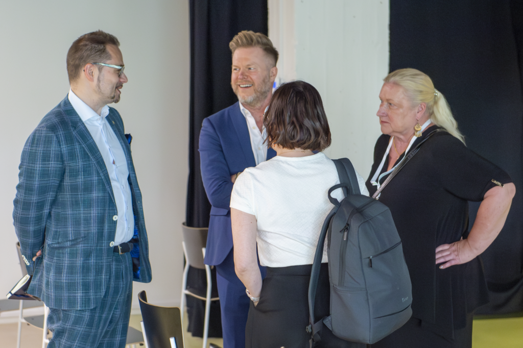 Aleksi Arpiainen networking with SIX Cluster members at launch event in Tampere